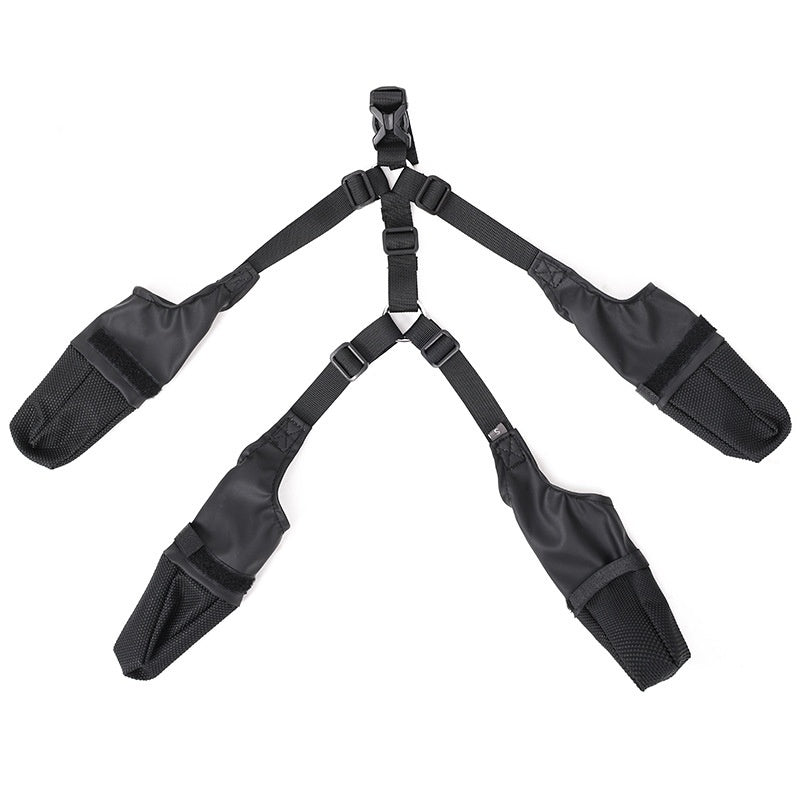 Black adjustable harness with four straps and padded sections, arranged in a symmetrical design.