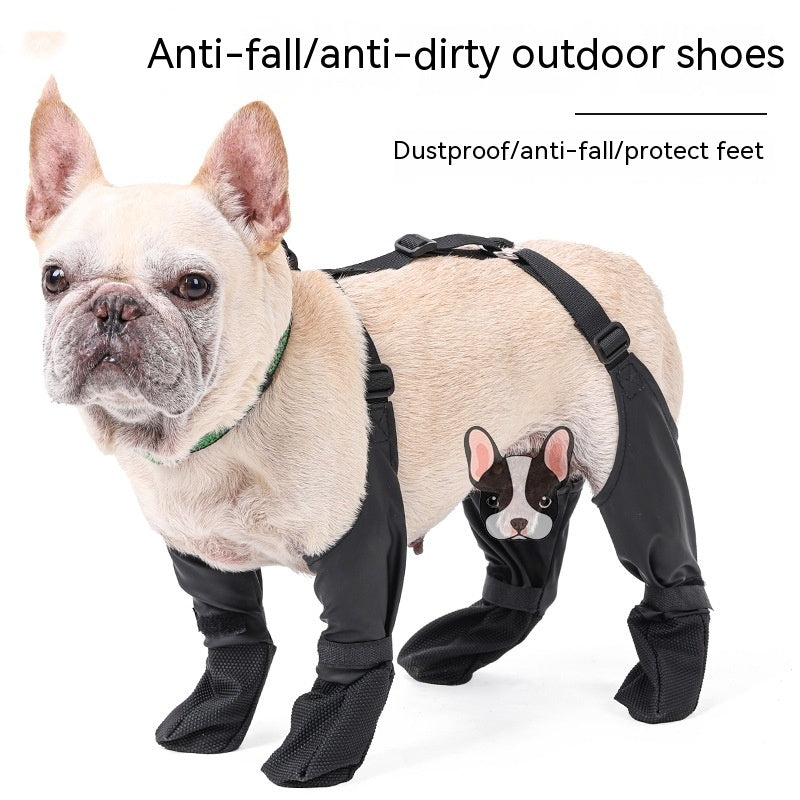 A French bulldog wearing black protective leg covers with a cartoon dog design on the side.