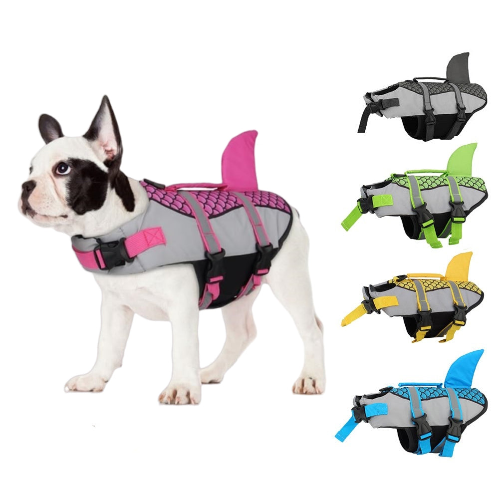 Dog in a gray and pink shark fin life jacket; four color options shown: gray, green, yellow, blue.
