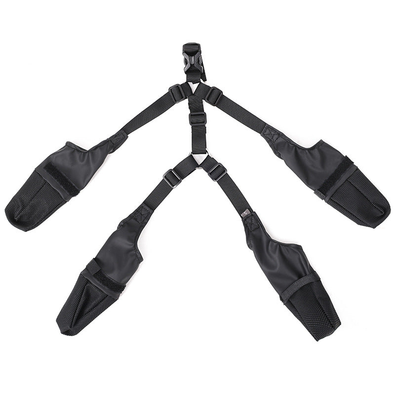Black adjustable harness with four straps and padded sections, arranged in a symmetrical pattern.
