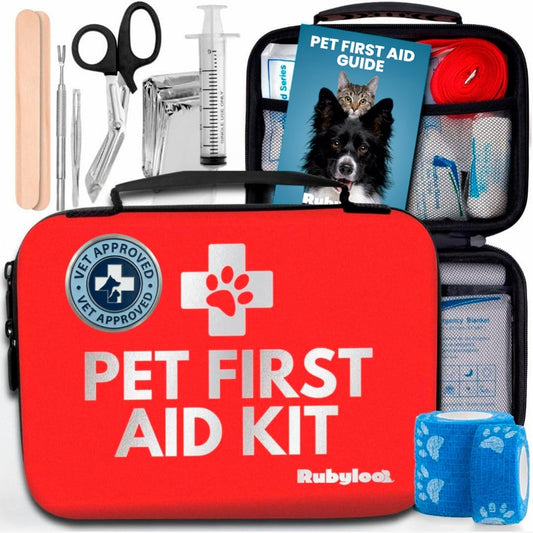 Red pet first aid kit with medical tools, bandages, and a guidebook, featuring a paw print logo.