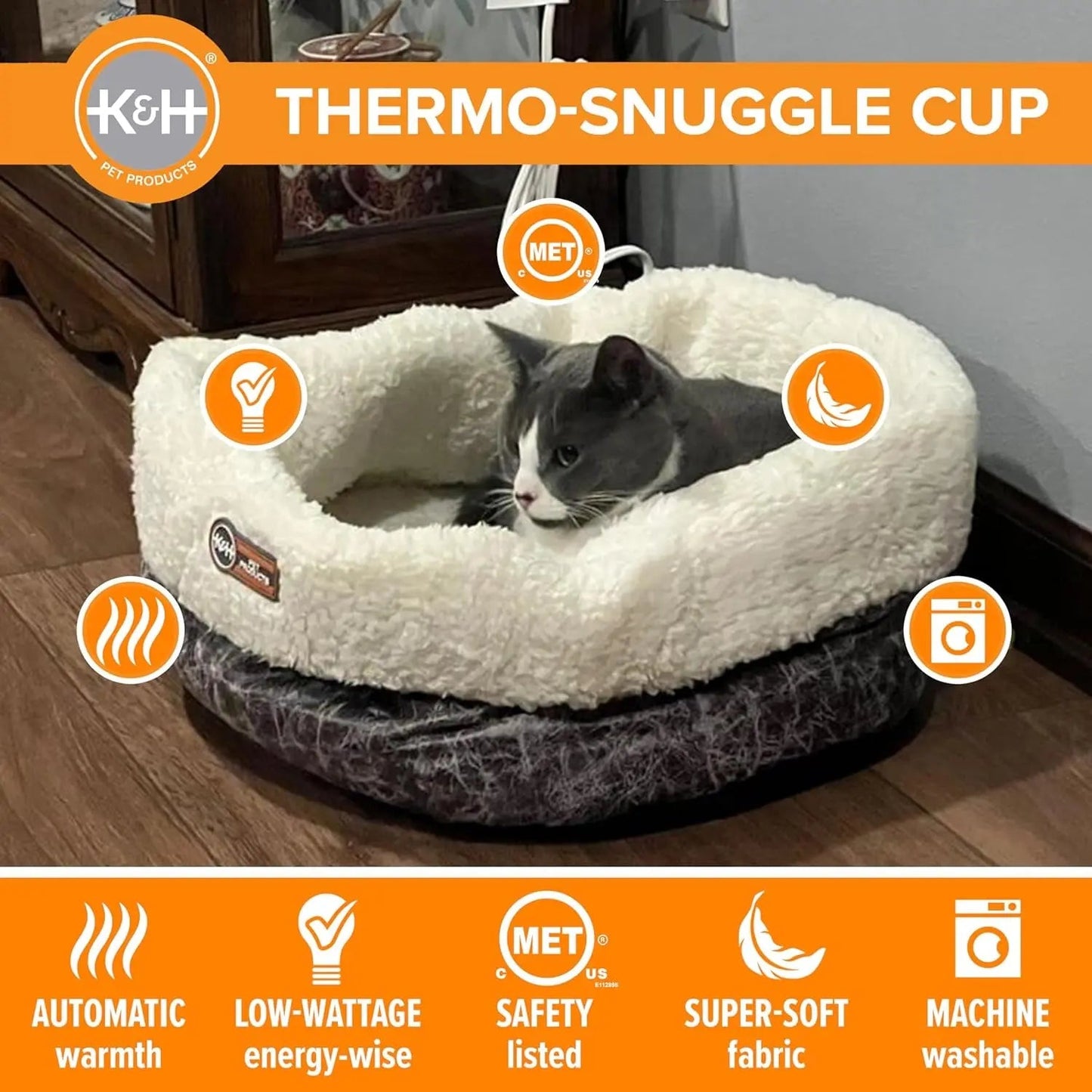 Gray and white cat in a fluffy, cream-colored heated pet bed with orange icons and text.