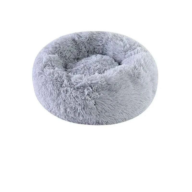Gray, fluffy, round pet bed with a plush texture and raised edges on a white background.
