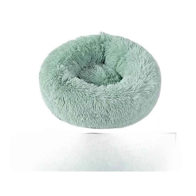 Fluffy mint green pet bed in a circular shape on a white background.