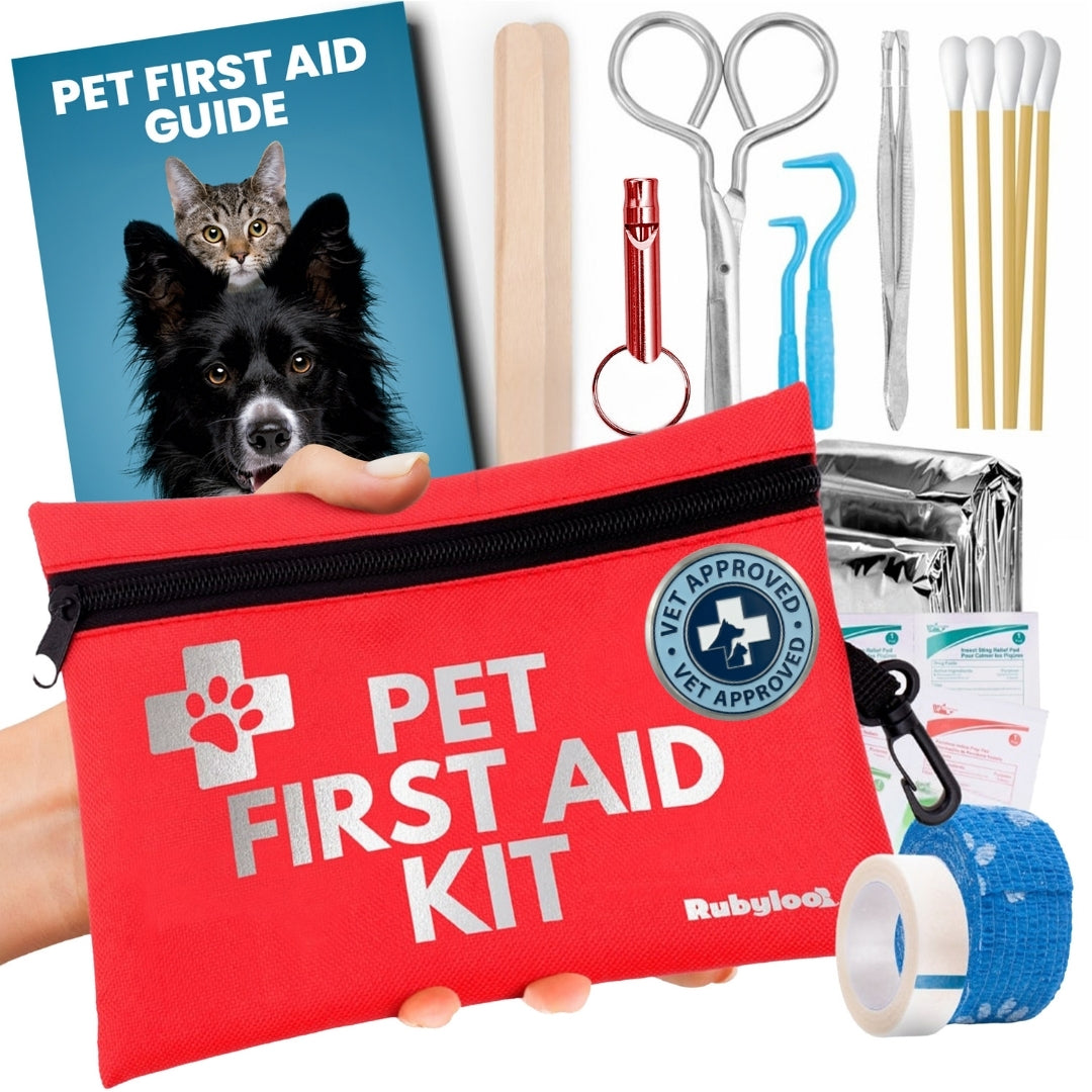 Red pet first aid kit with tools, guidebook, and blue bandage on a white background.