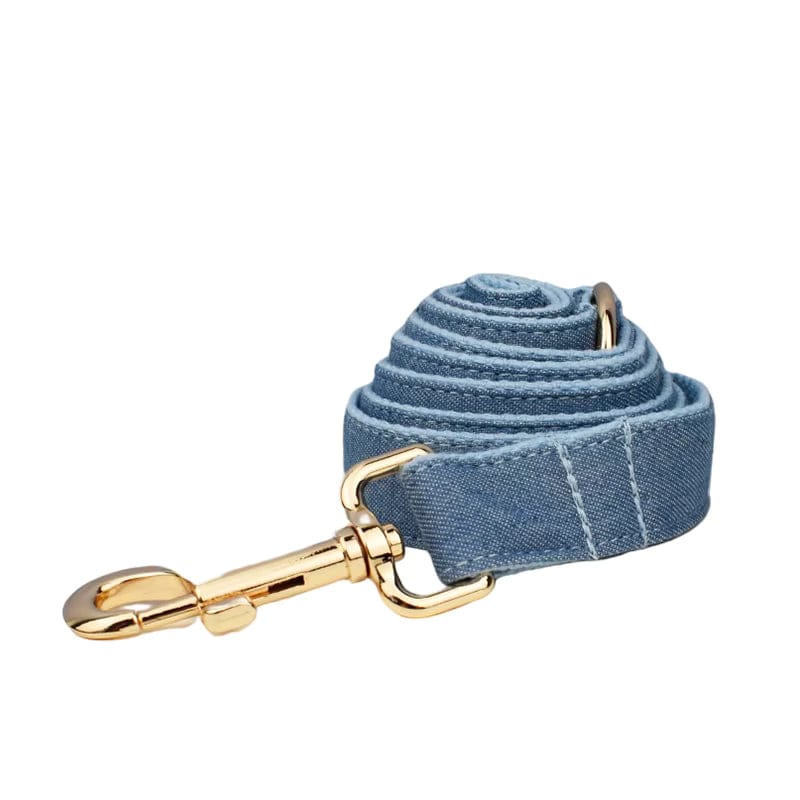 Blue denim strap with gold clasp, coiled neatly on a white background.