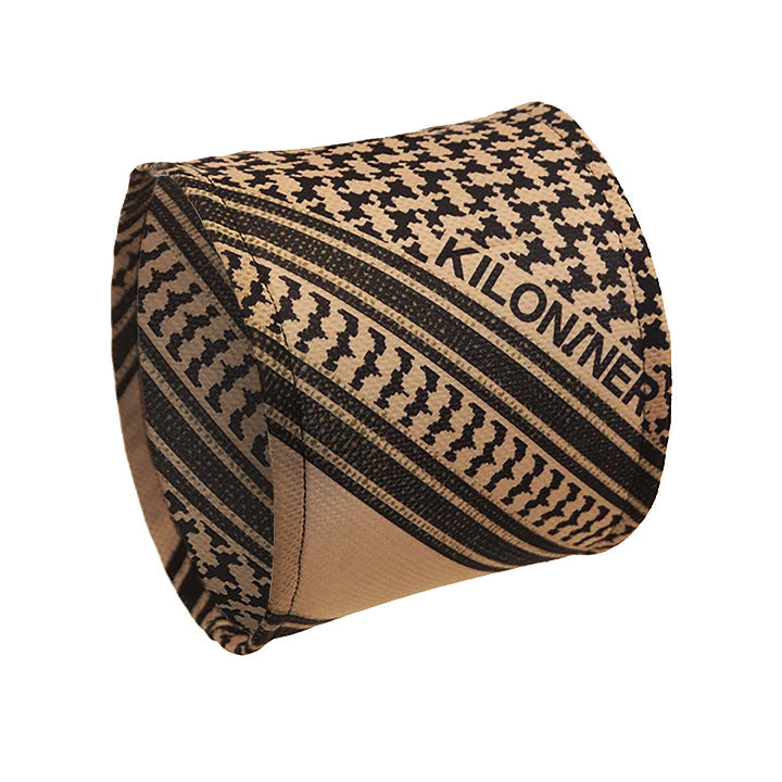 Tan and black patterned fabric with "KILONINER" text, featuring geometric and stripe designs.